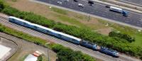 A highway and a passenger train from above